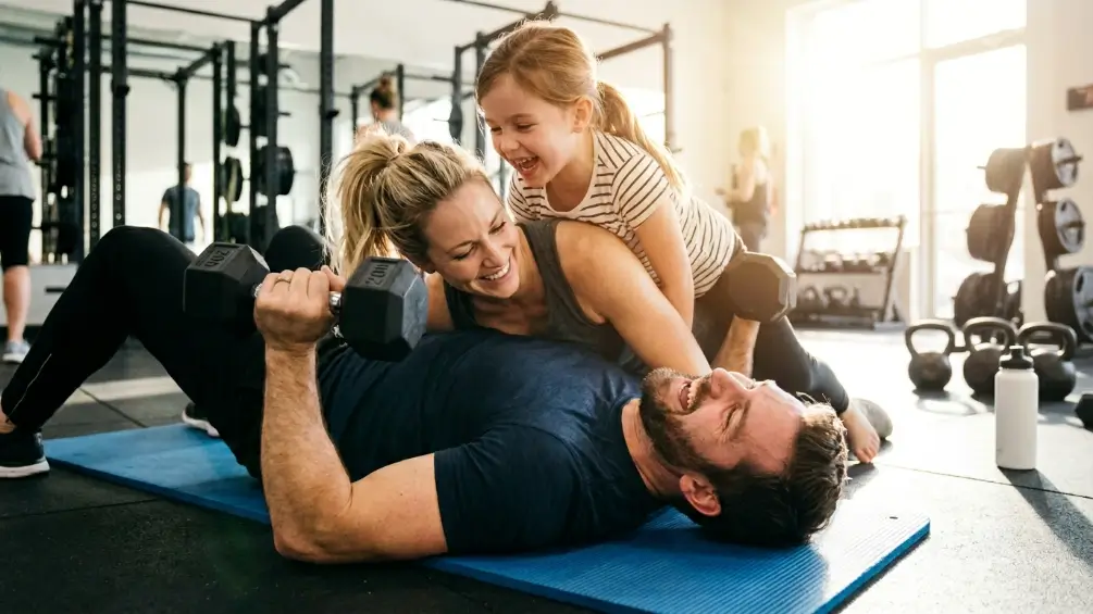 Members exercising together on the gym floor at David Lloyd Glasgow Renfrew with modern fitness equipment